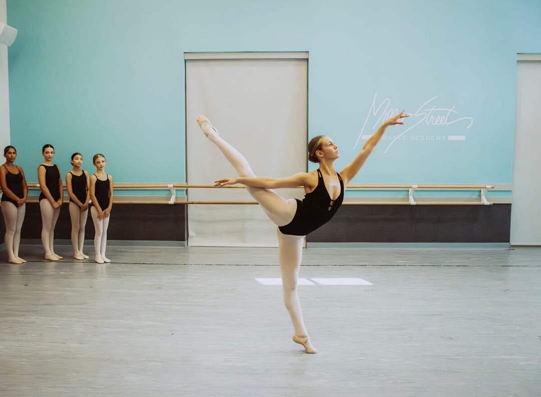 Ballet dancer in arabesque with students observing at MSDA
