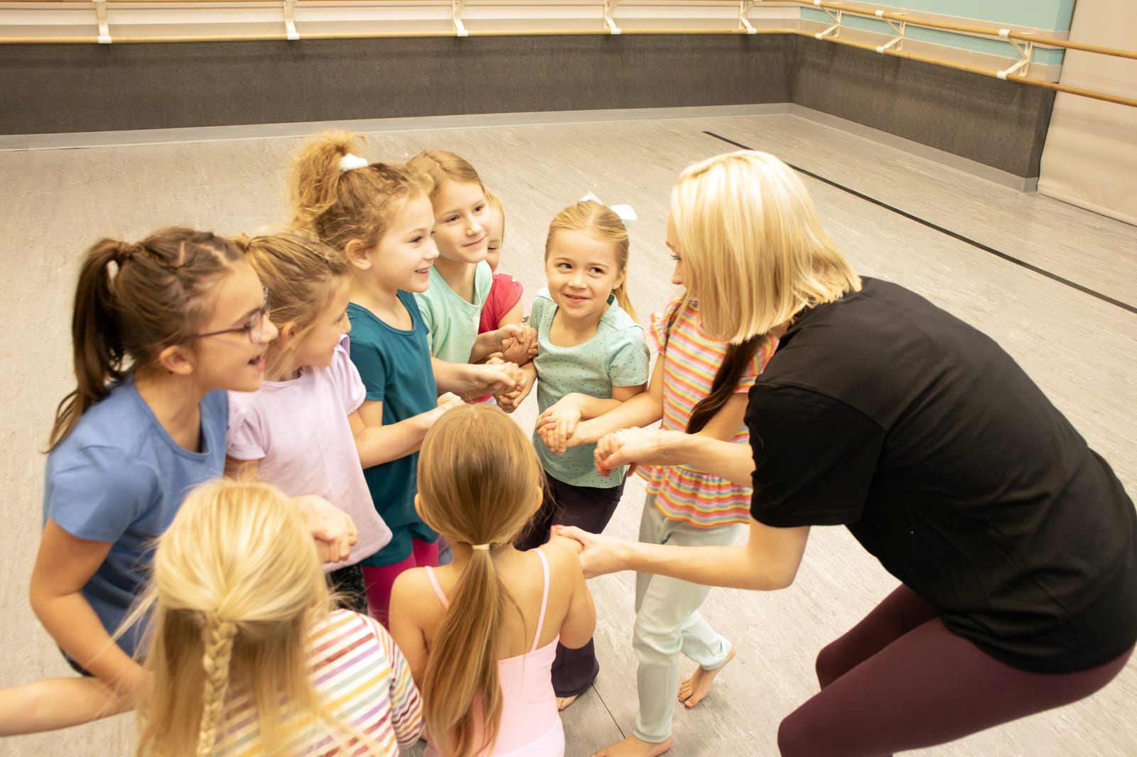 Campers and staff in a circle during a summer dance camp activity